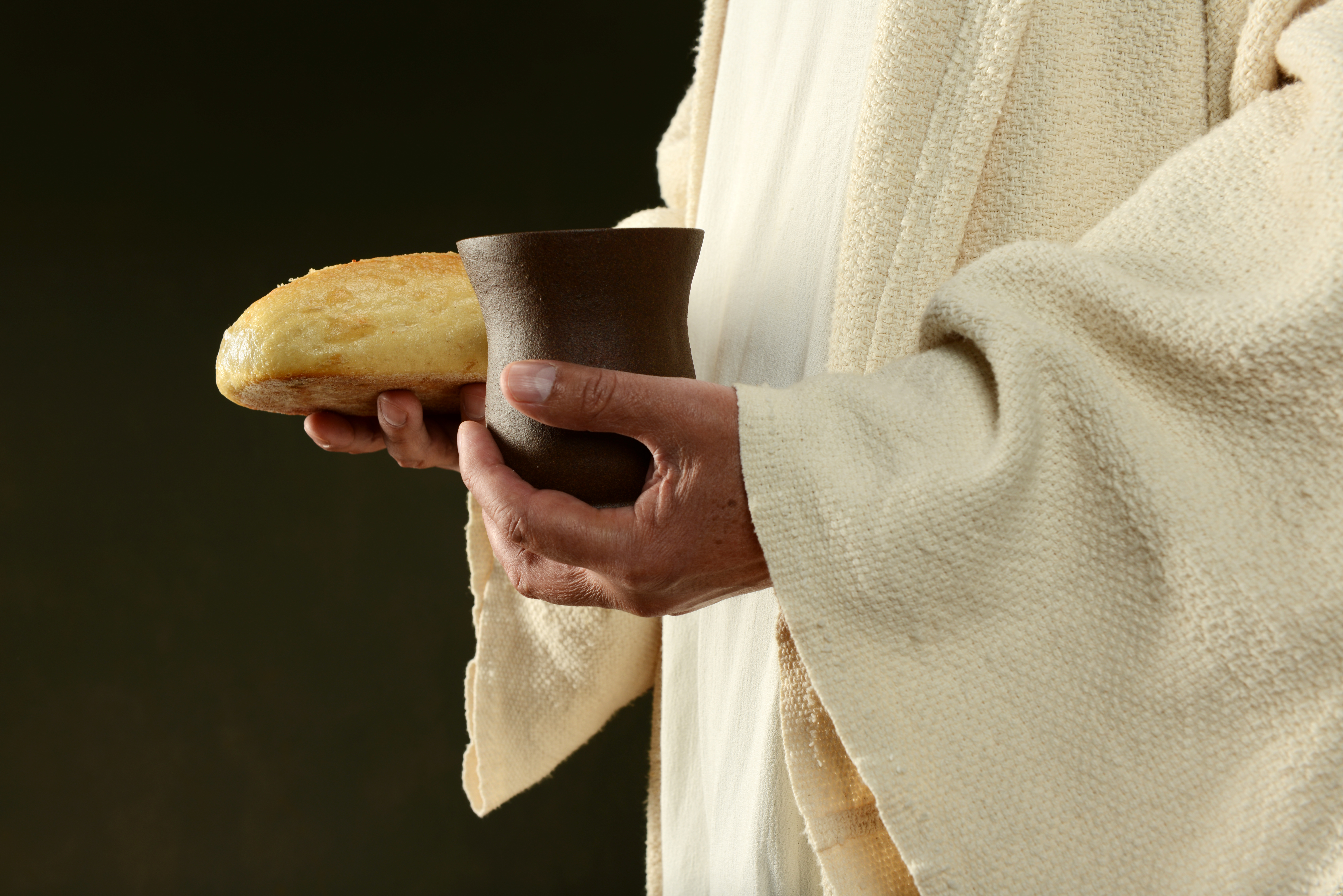 Jesus holding bread and a cup of wine